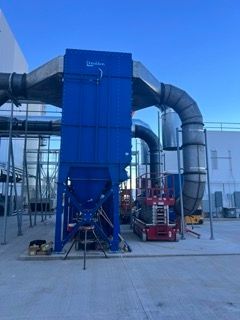 A large blue building with a lot of pipes coming out of it