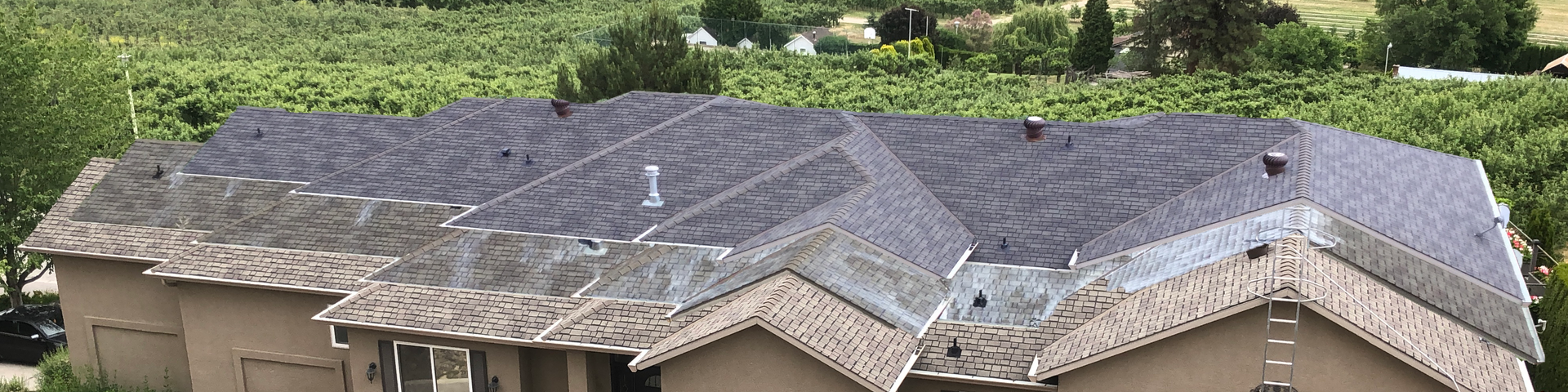 A row of houses with a roof that is covered in shingles.