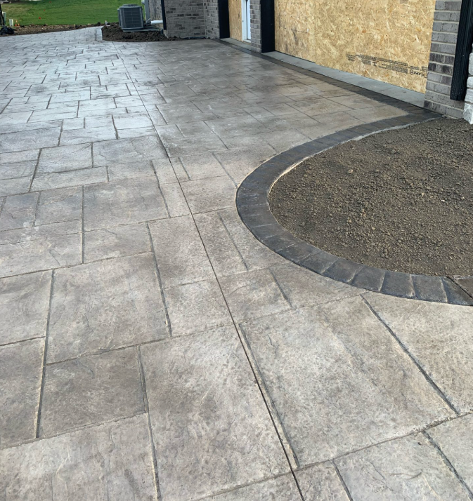A concrete driveway with a circle in the middle