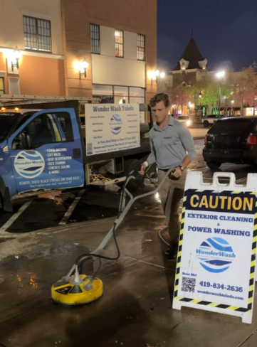 A man is standing next to a sign that says caution