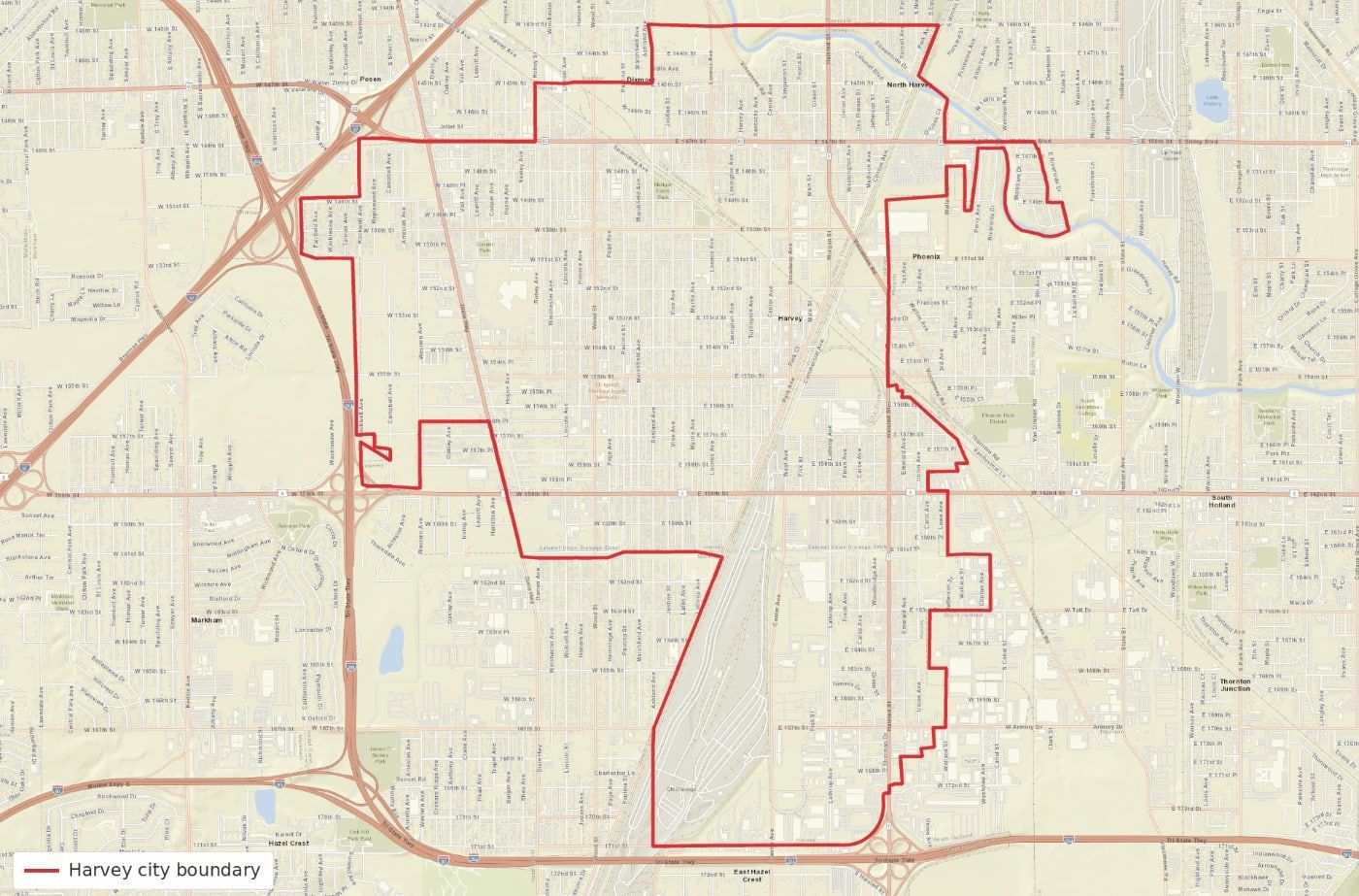 Map with a red outlined boundary over a street grid background.