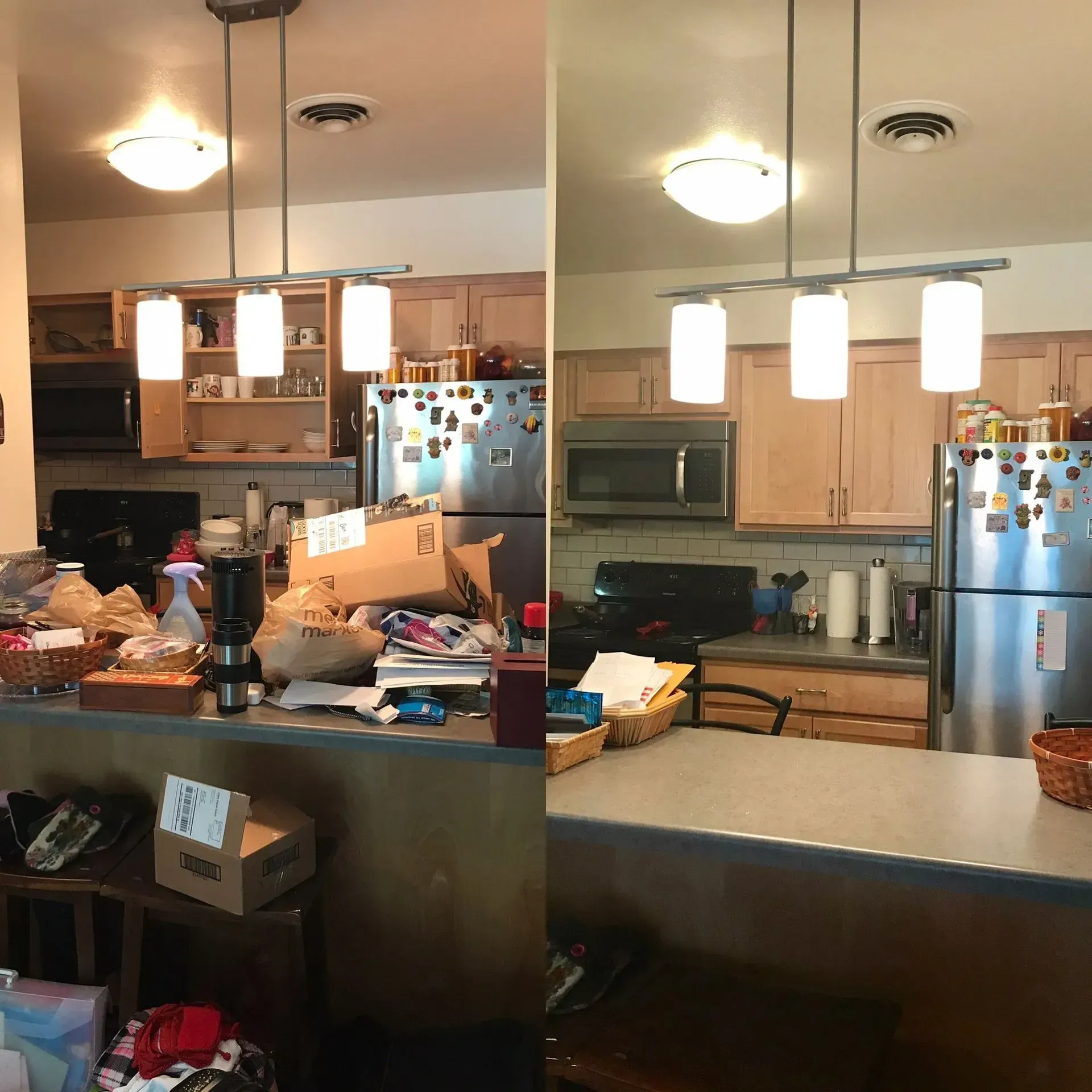 Cluttered kitchen with refrigerator, stove, cabinets, hanging lights, and a counter covered in items.