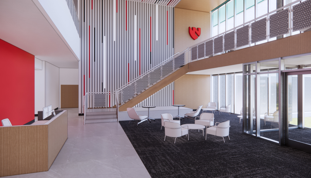 Modern lobby with stairs, seating, and red accents.