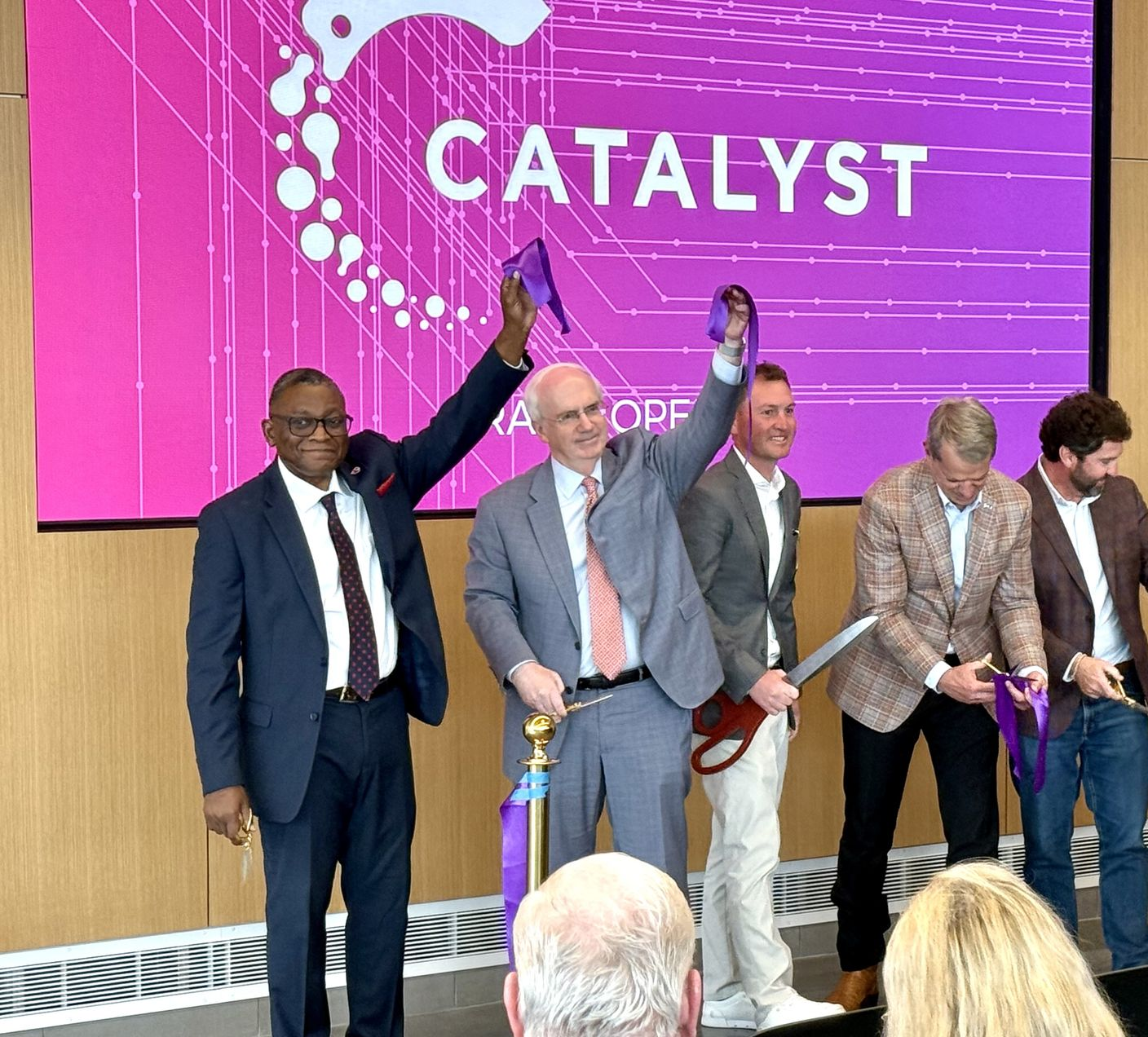 People cutting ribbon at 