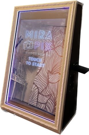 assistant standing near mirapix mirror photobooth
