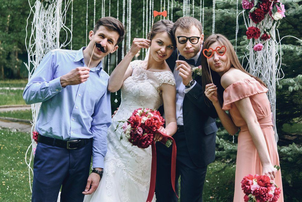 image of four people standing infront of a photobooth