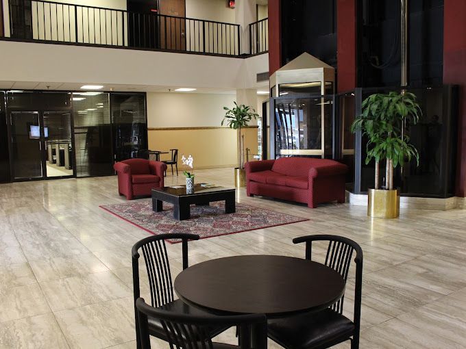 A lobby with a table and chairs and a couch