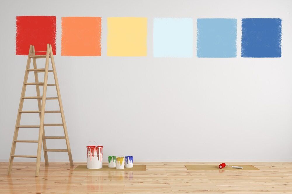 A Wooden Ladder is Leaning Against a Wall Next to Buckets of Paint — Prota NT in Palmerston, NT