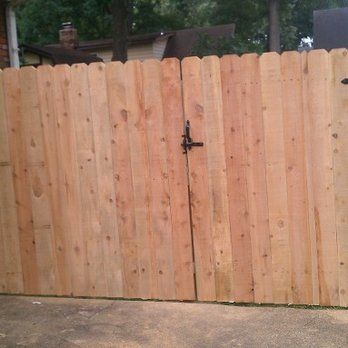 A wooden fence with a gate attached to it.