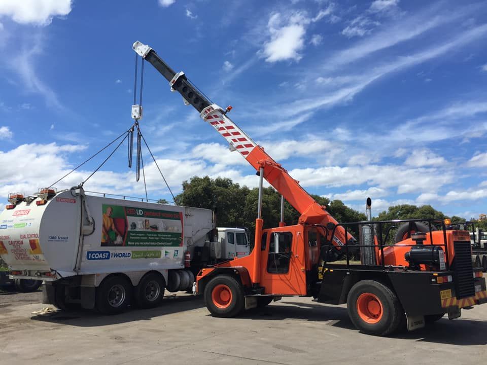 A Man Is Working On A Street Light On A Lift — Port Stephens Cranes In Nelson Bay, NSW