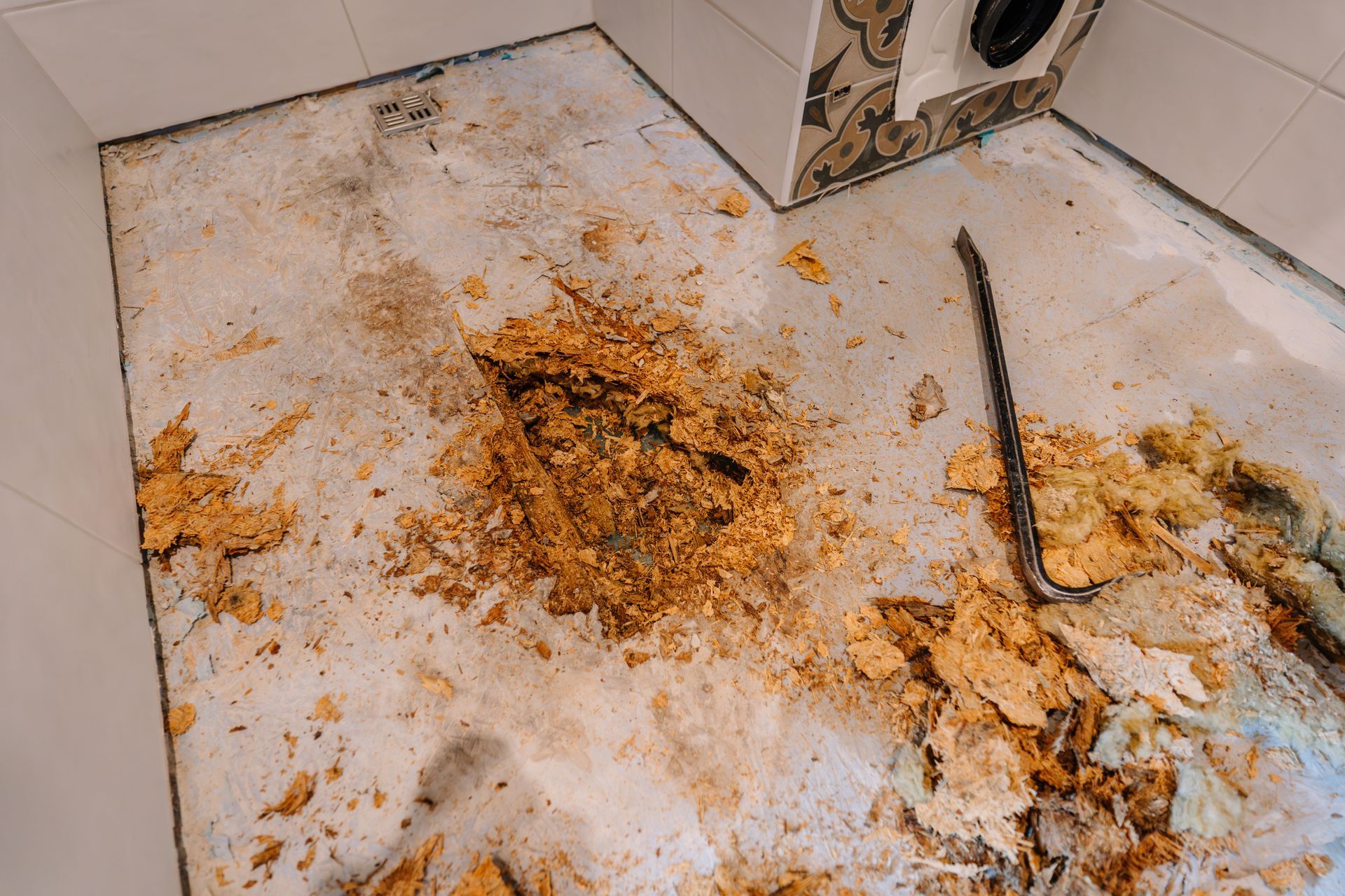 Industrial drying fans set up on a wet hardwood floor after water damage.