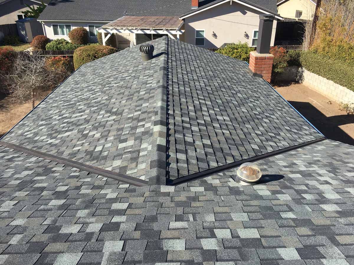 Roof under construction with gray shingles on a residential house