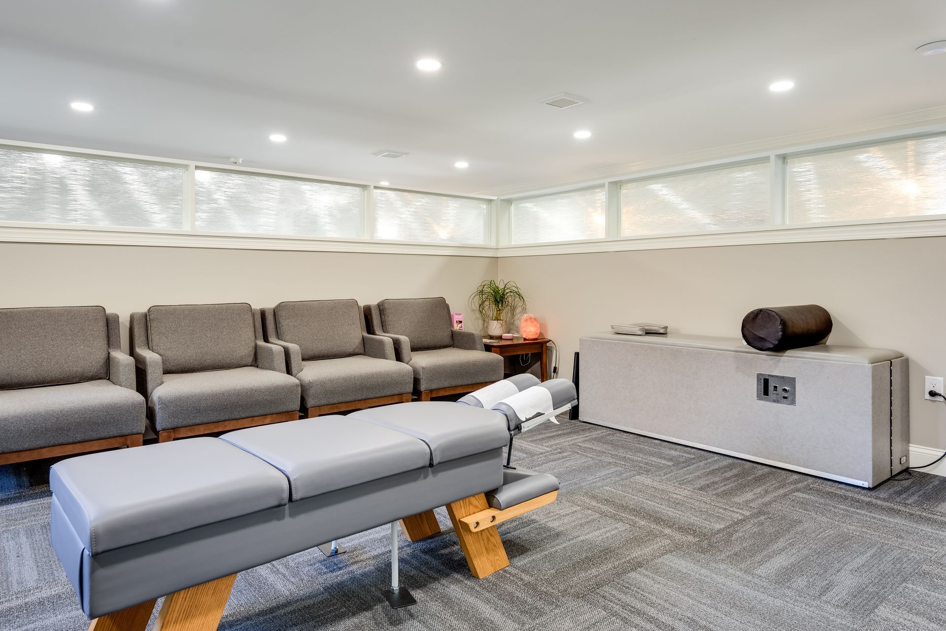A waiting room with a table and chairs in it.