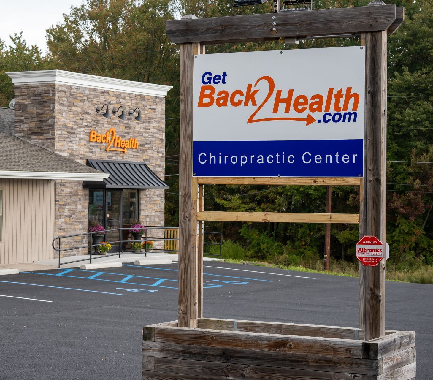 A back health sign on a brick wall