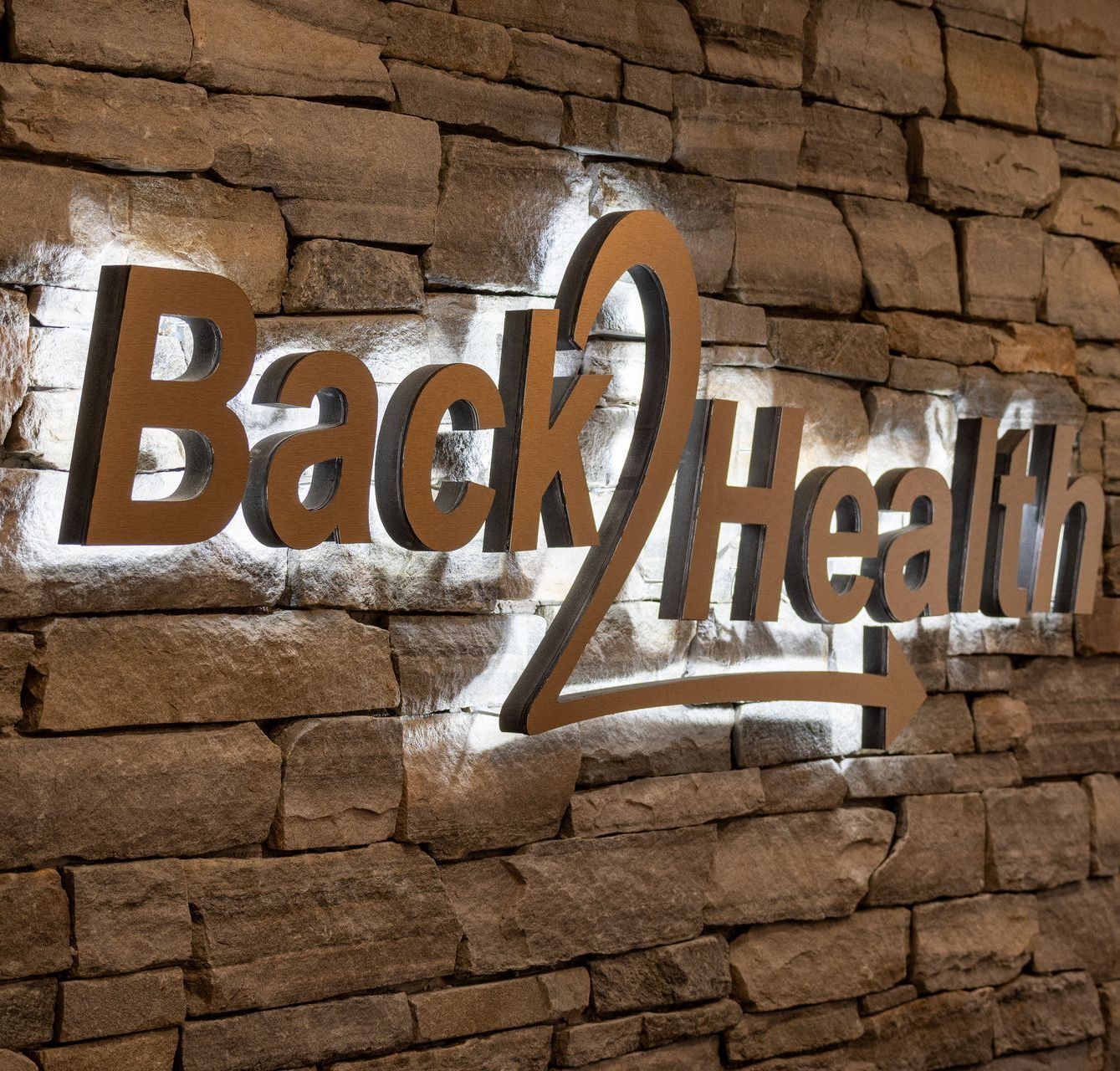 A back health sign on a brick wall