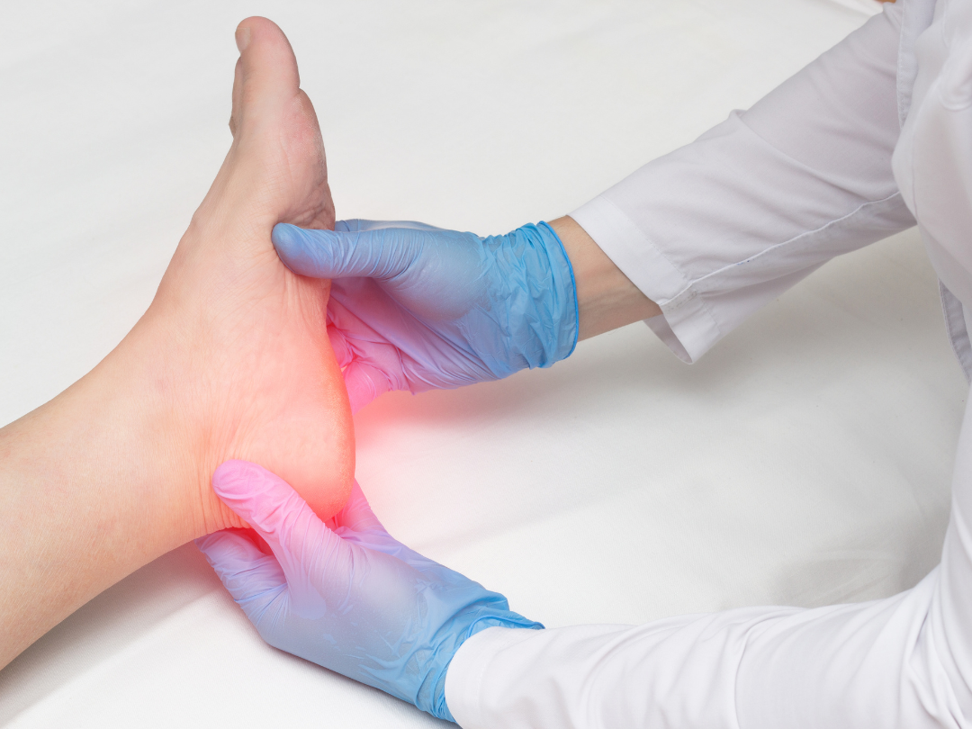 A doctor is examining a patient 's foot with blue gloves.