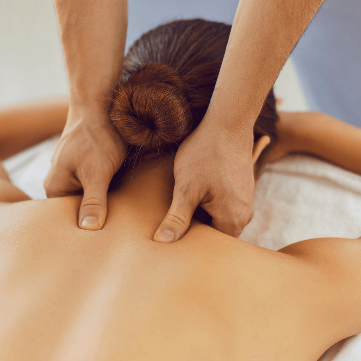 A woman is getting a massage from a man.