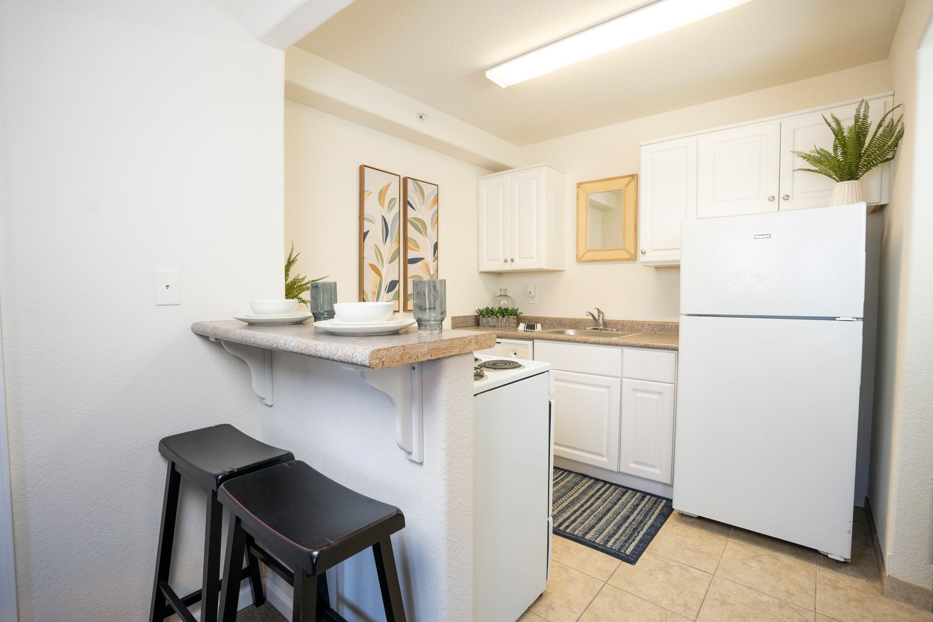 pretty white kitchen with 2 stools