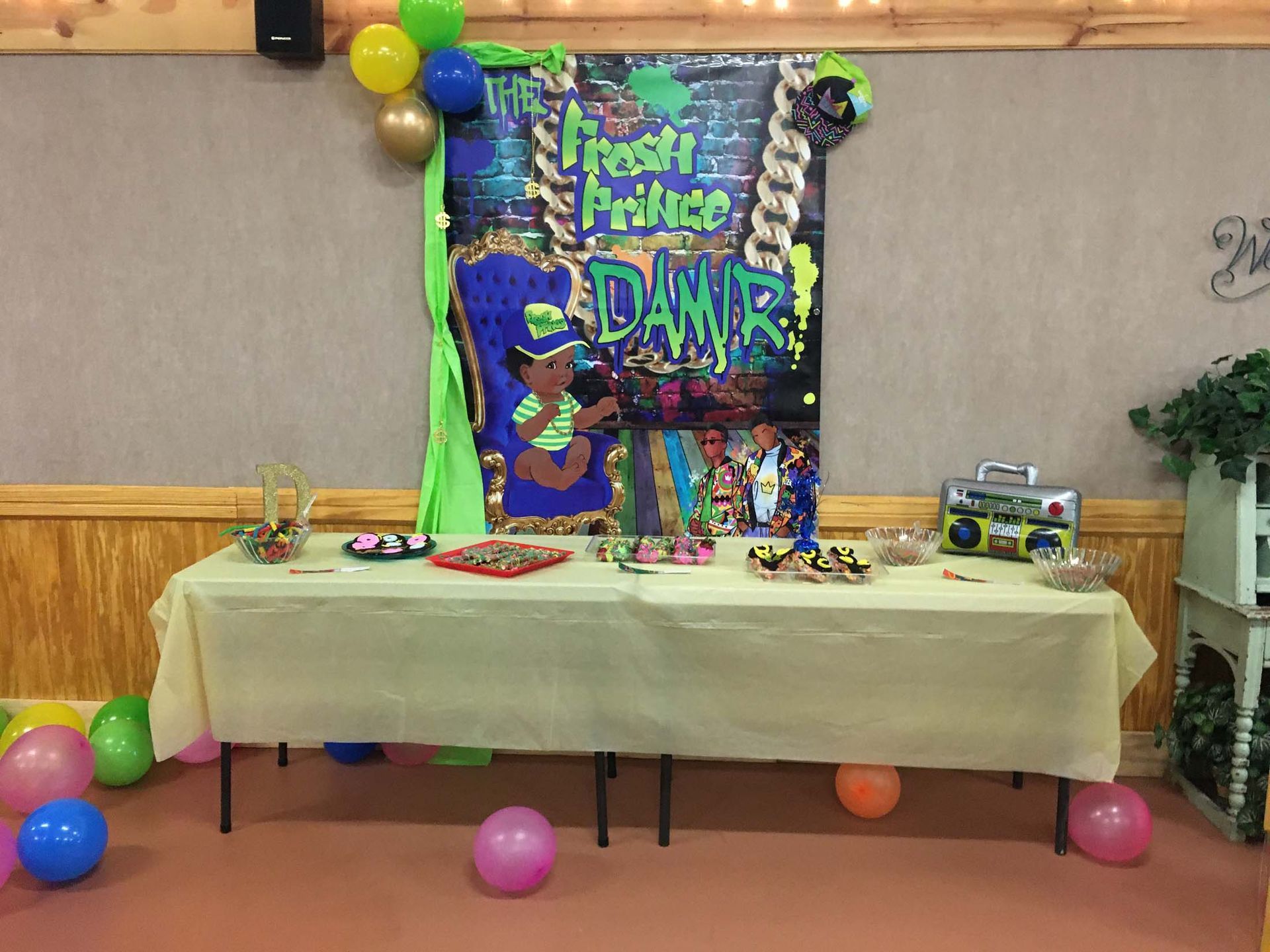 Decorated table with balloons and colorful “Future DAD” banner at a baby shower