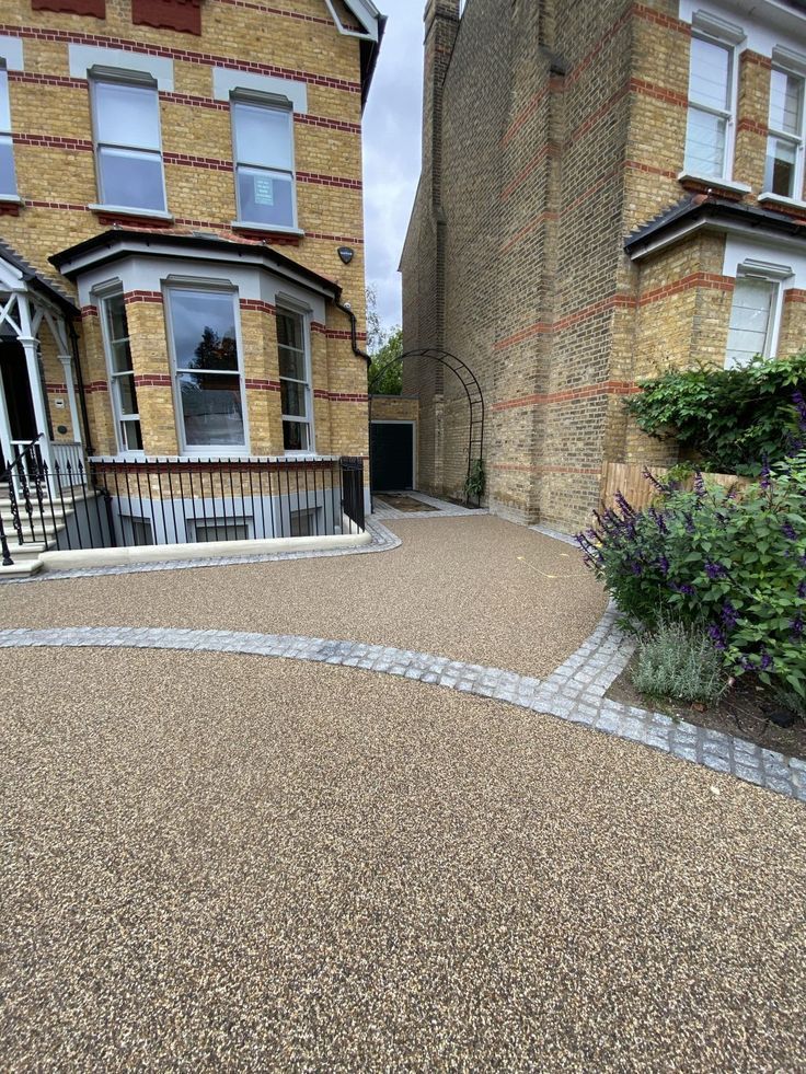 A brick house in Essex with a resin bound gravel driveway in front of it. Installed by Essex Resin driveways