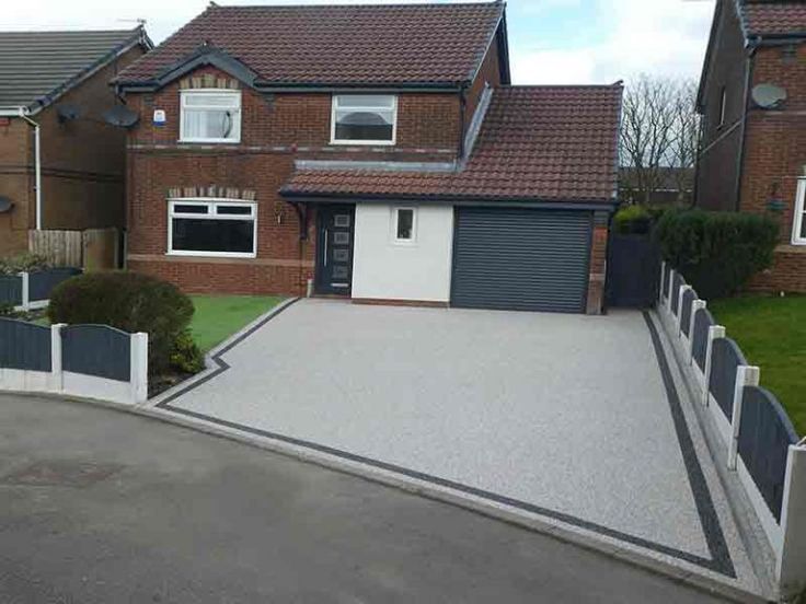 A large brick house in Harlow, Essex with a large resin bound driveway in front of it. Installed by Essex Resin driveways