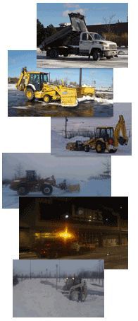 Vehicles clearing snow: dump truck, backhoes, and a front-end loader on snow-covered ground. Night scene with lights.