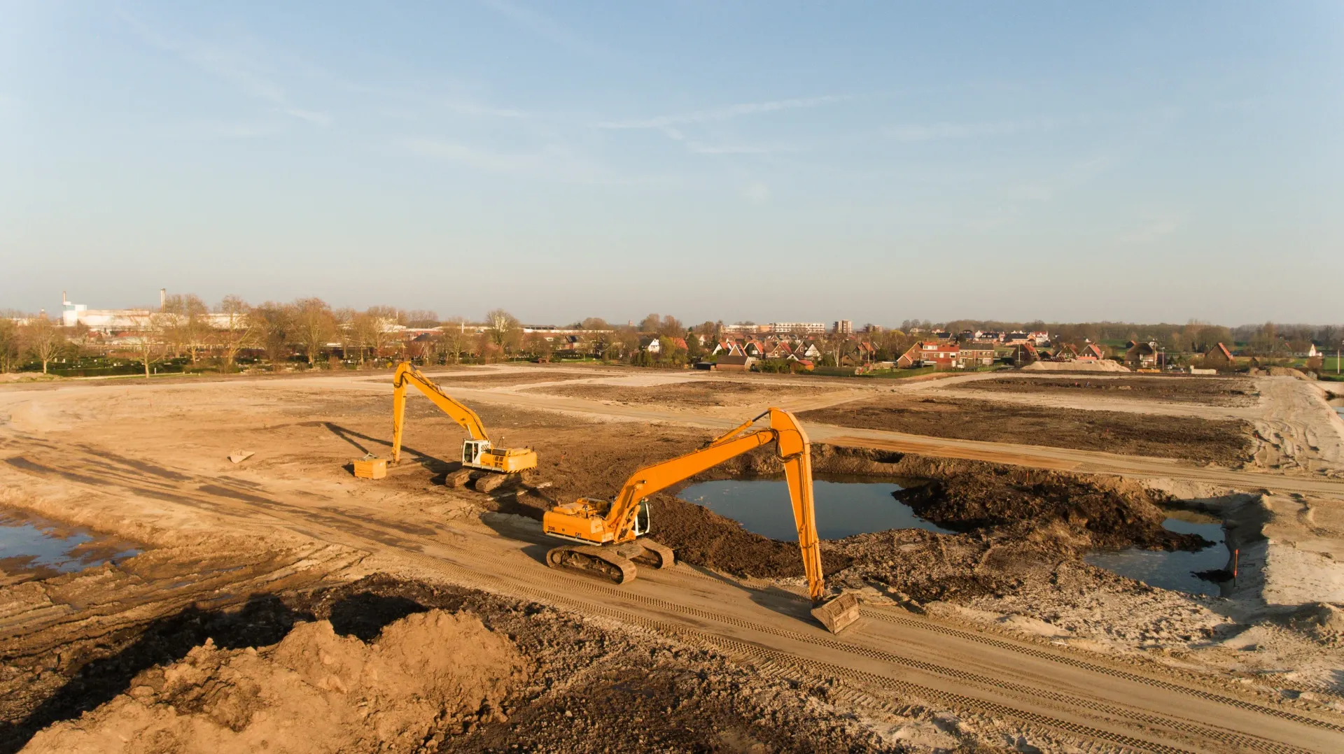 Malaysia Nanyang expertise's two excavators clearing land at a construction site.