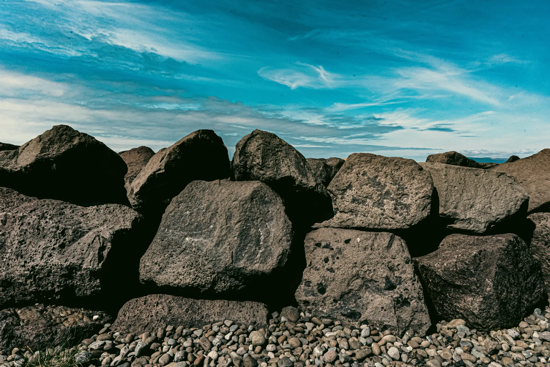 The Large natural stones represent quarry-sourced raw materials like crusher run, vital for construction projects.
