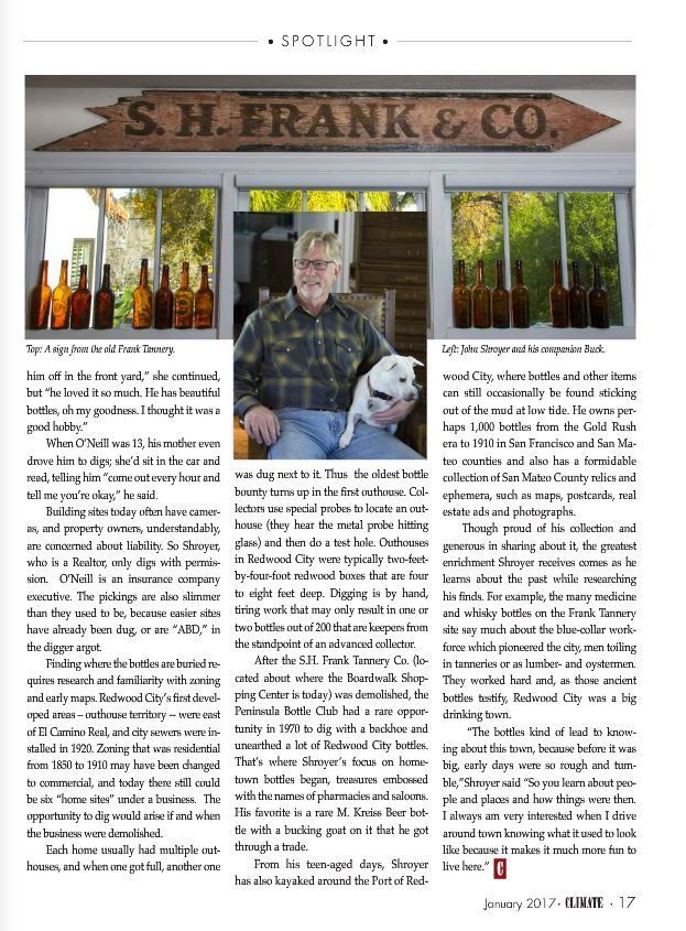 Magazine article featuring a man seated in a storefront window with bottles displayed around him