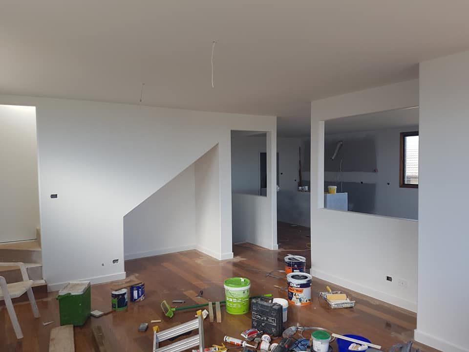 Messy Empty Room With Wooden Floors, White Walls, and Scattered Paint Supplies — Damien Thompson Plastering King Creek, NSW