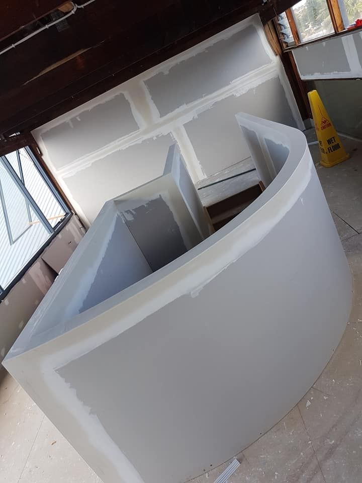 White Curved Countertop or Booth Under Construction in a Workshop — Damien Thompson Plastering King Creek, NSW