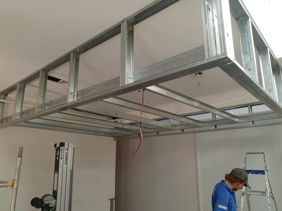 Partially Built Ceiling Framing in a Room, With a Worker and Ladder Below — Damien Thompson Plastering King Creek, NSW