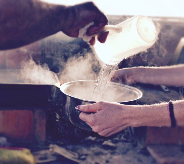 pouring boiling water in a pan