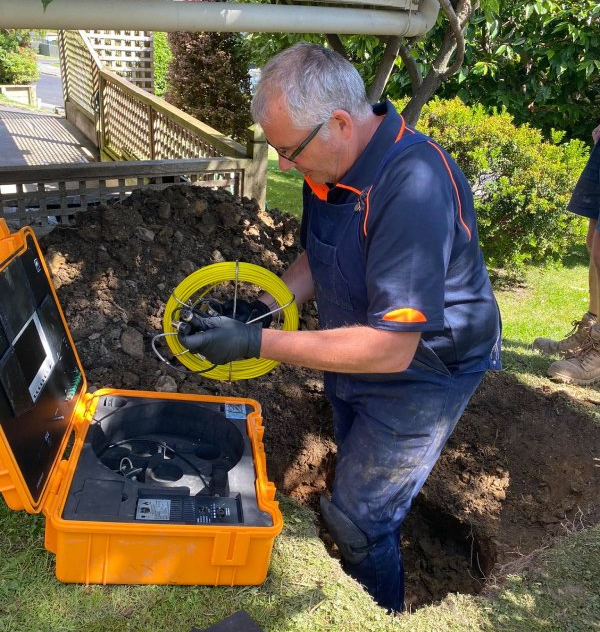 a plumber setting up a drainage inspection
