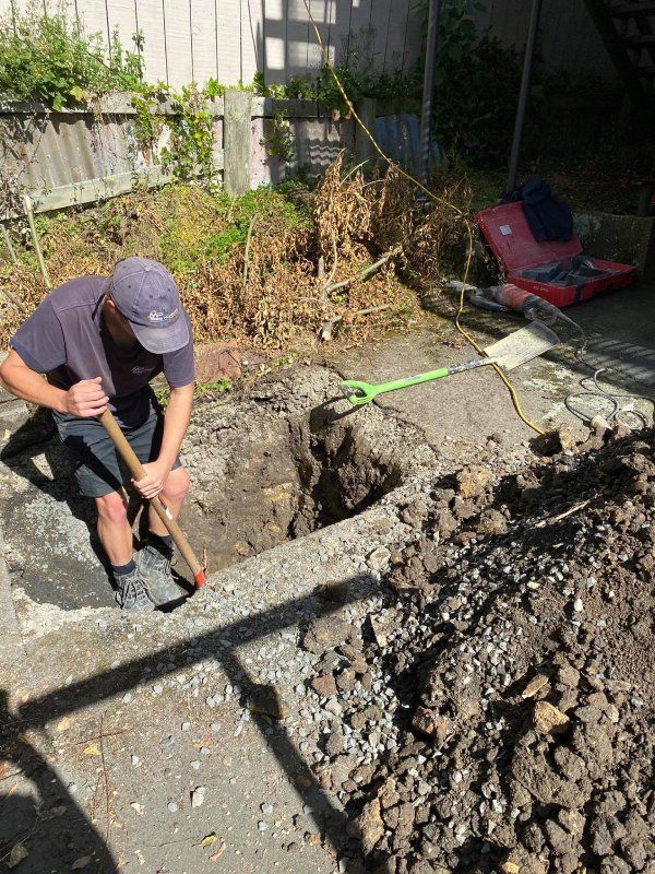 Plumber digging the ground for drainage