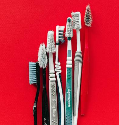old toothbrush for cleaning up the shower head