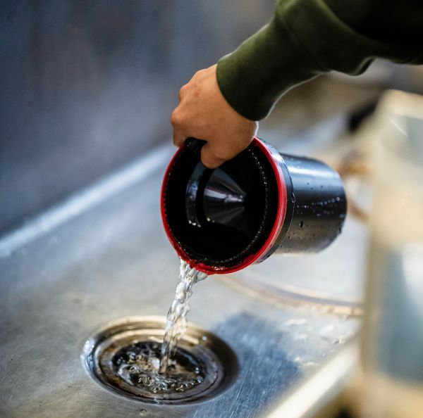 pouring water down the drain