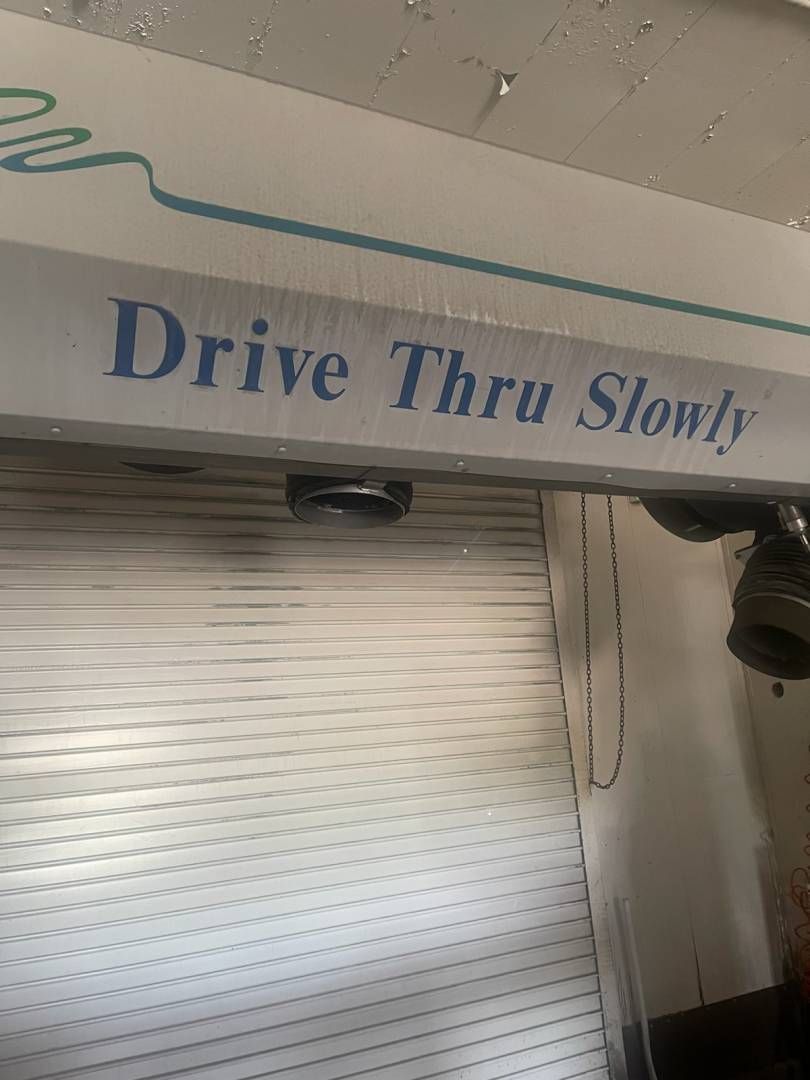 A sign that says drive thru slowly on it