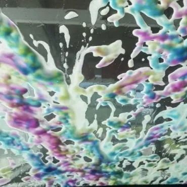 A close up of a colorful foam on a window