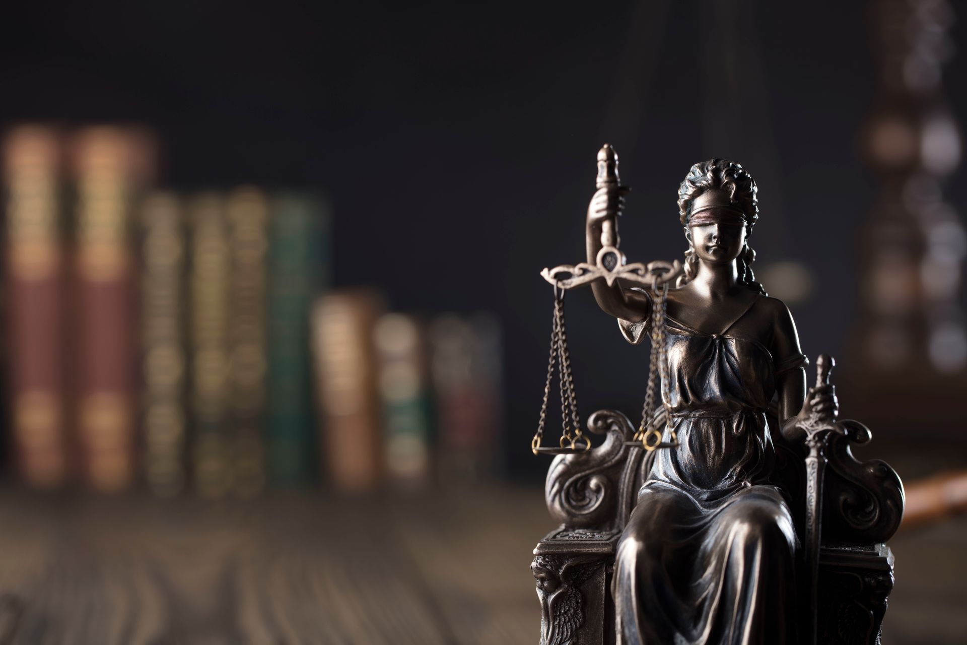 Statue of a person holding a sword and scales.