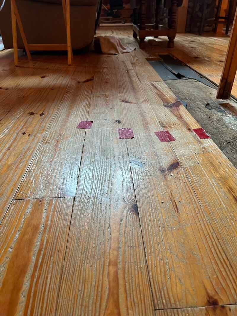 A close up of a wooden floor in a living room.