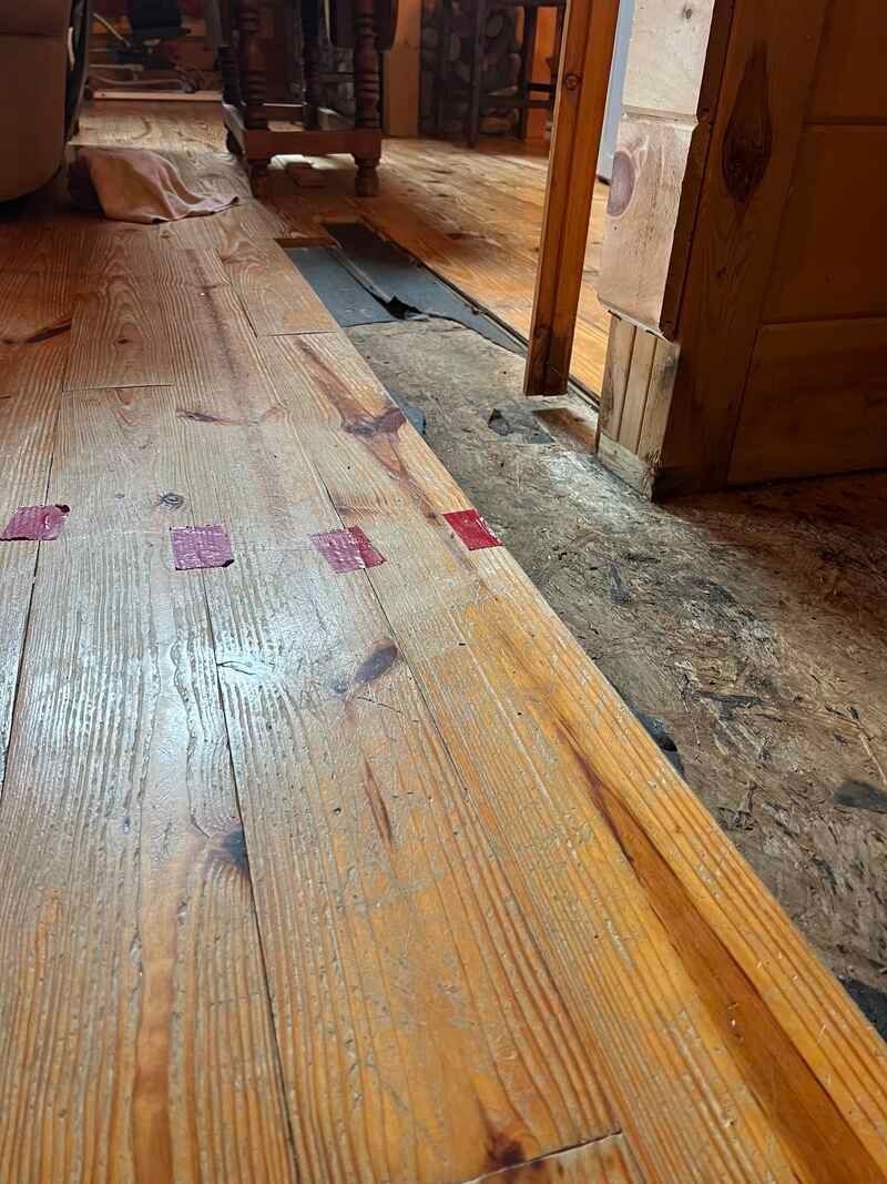A close up of a wooden floor in a room.