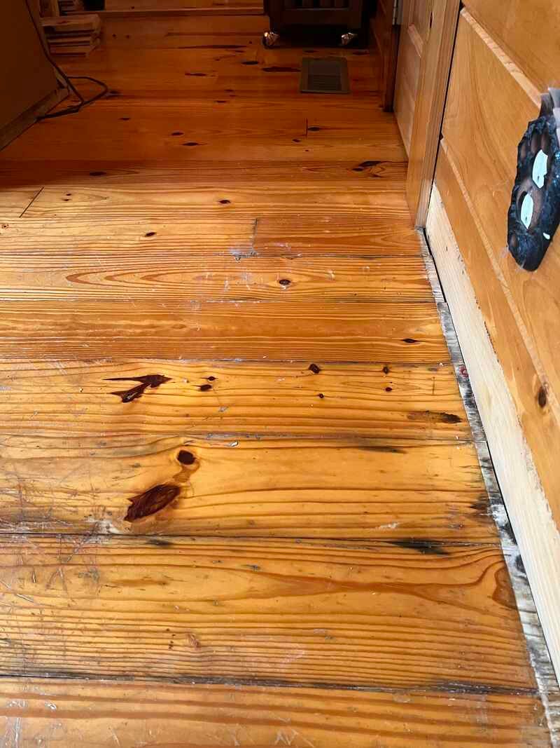 A close up of a wooden floor in a room.