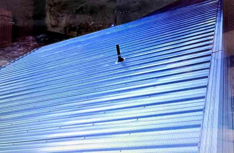 A blue roof with a chimney on top of it.