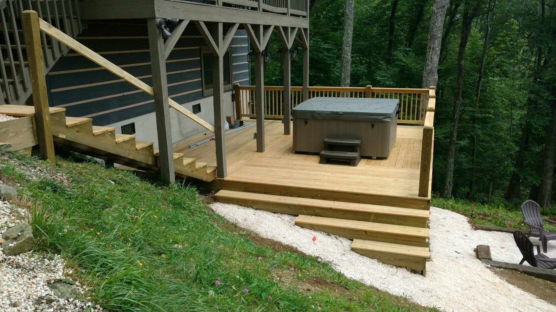 There is a hot tub on the deck of a house.