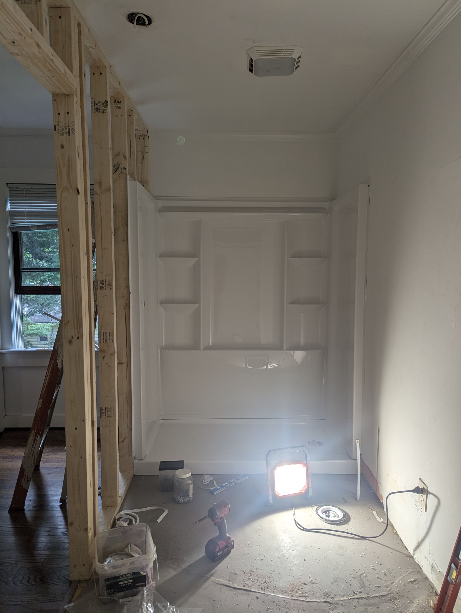 A room under construction with a light on the floor