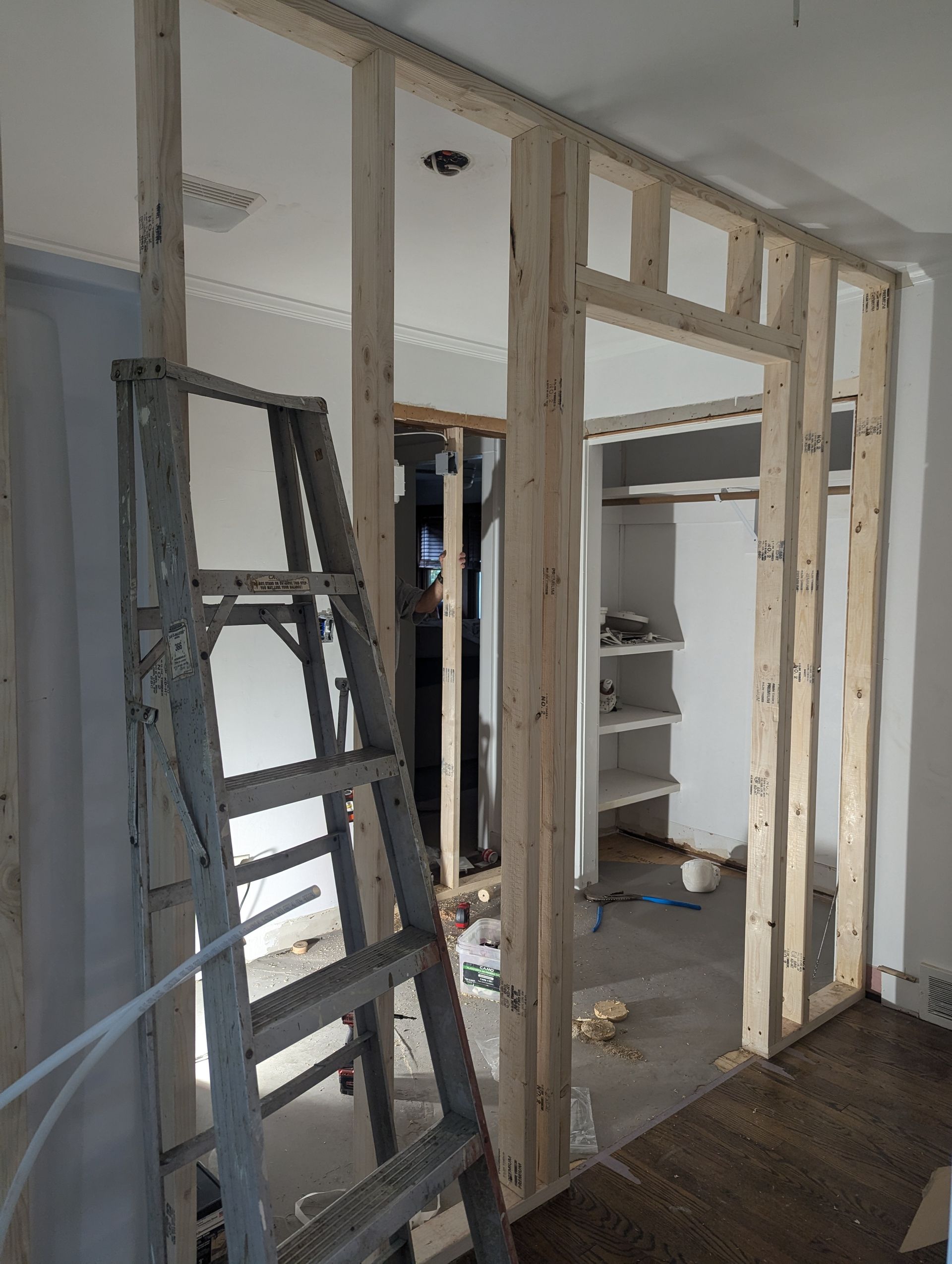 A ladder is sitting in a room with a wooden frame.
