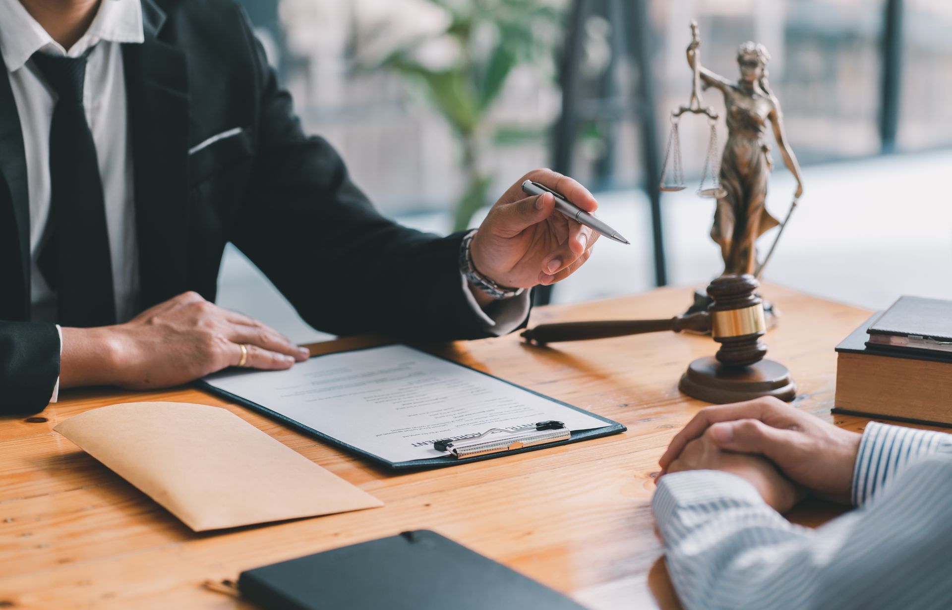 Attorney And Client Signing A Document