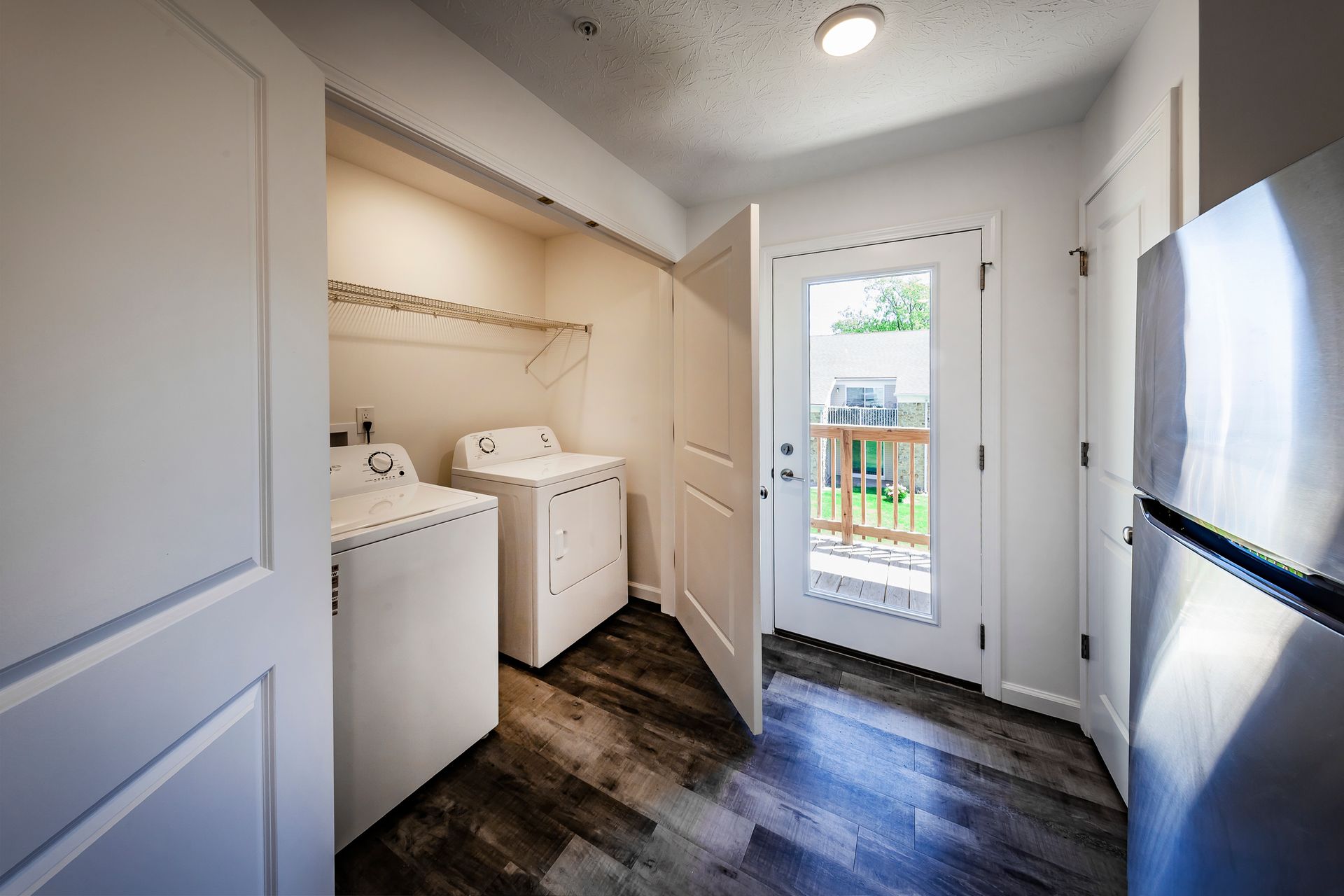 White kitchen counter with cabinets. Orchid and framed sign that reads