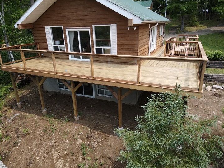 An aerial view of a house with a large deck